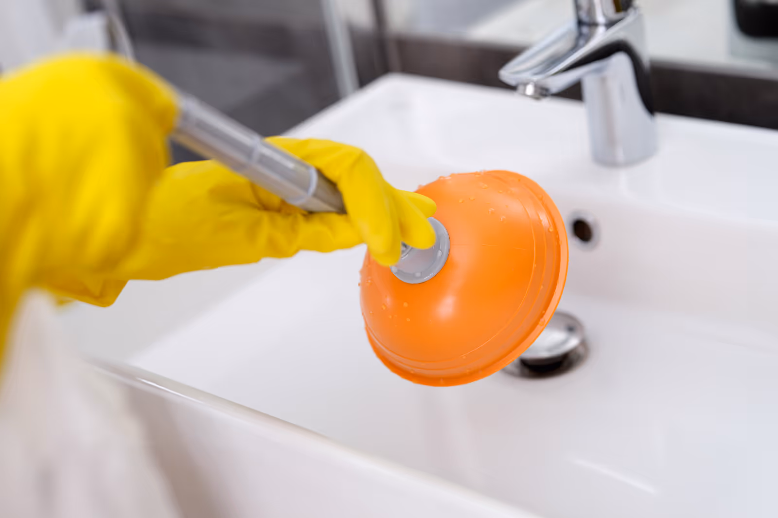 A house plunger designed for effective clog removal, featuring a rubber suction cup and a sturdy handle for easy use in sinks and toilets.